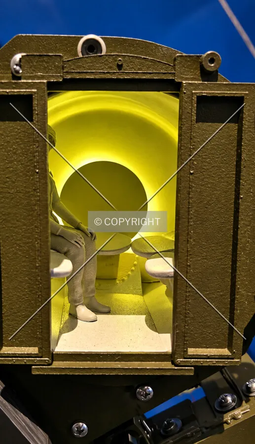 A minature replica of a person inside one of the pods that take visitors to the top, located in the lower level, Sunday, October 4, 2026