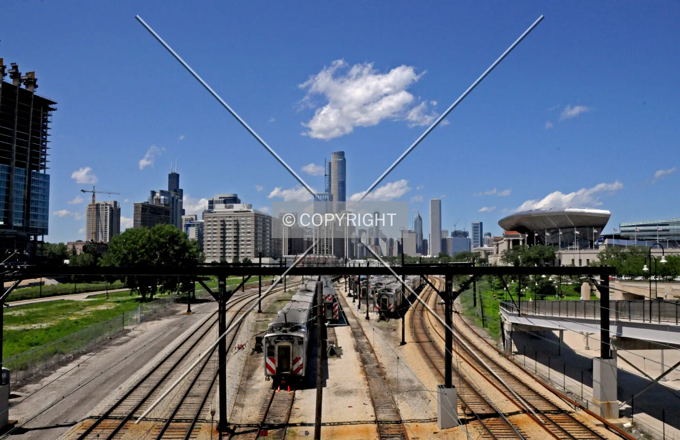 Bisecting the skyline view, looking north from the 18th Street pedestrian bridge over the the Metra Electric and South Shore Railroads