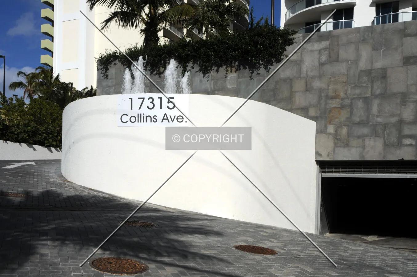 View of the entrance to the parking garage from the west along Collins Avenue