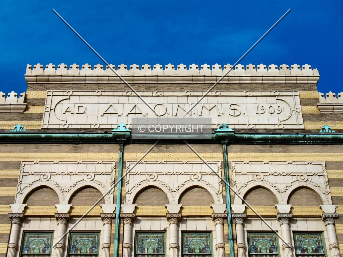 A.A.O.N.M.S., which stands for the Ancient Arabic Order Nobles of the Mystic Shrine, emblazoned atop the south facade