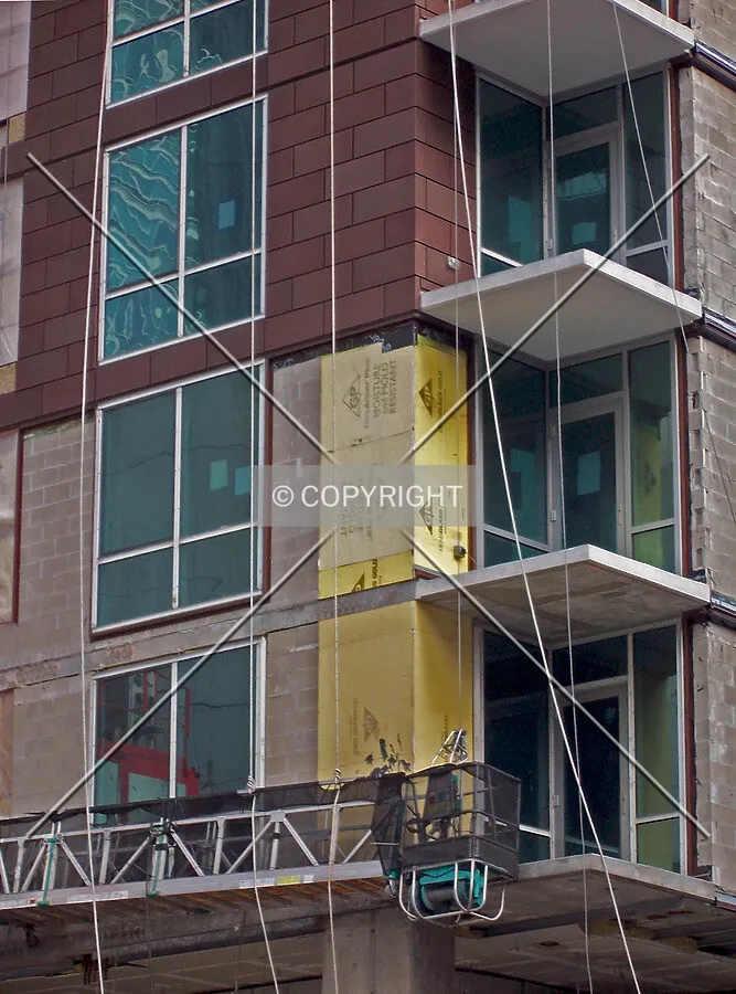 Unfinished cladding at the lower floors, on the southwest corner