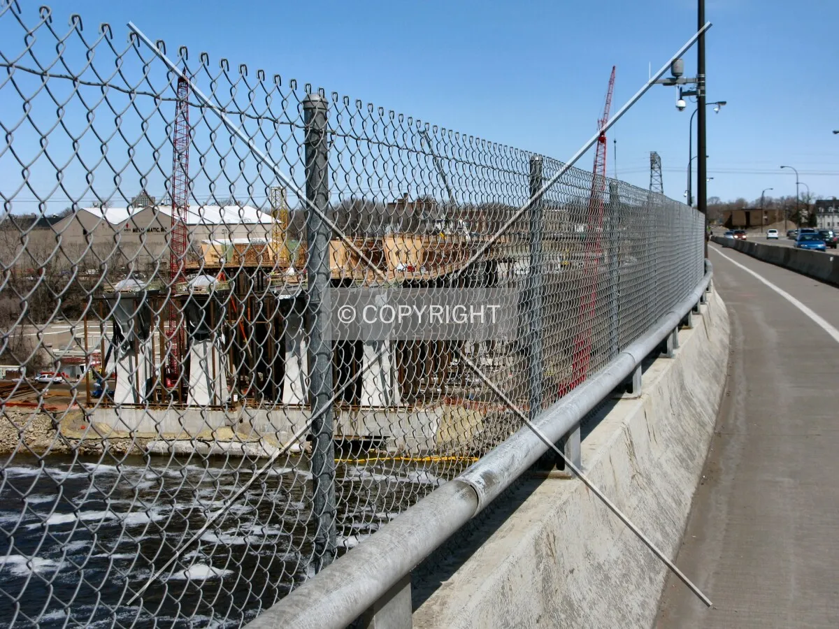 View to the north along the 10th Avenue Bridge, temporary fencing and sidewalk along the west side facing new construction