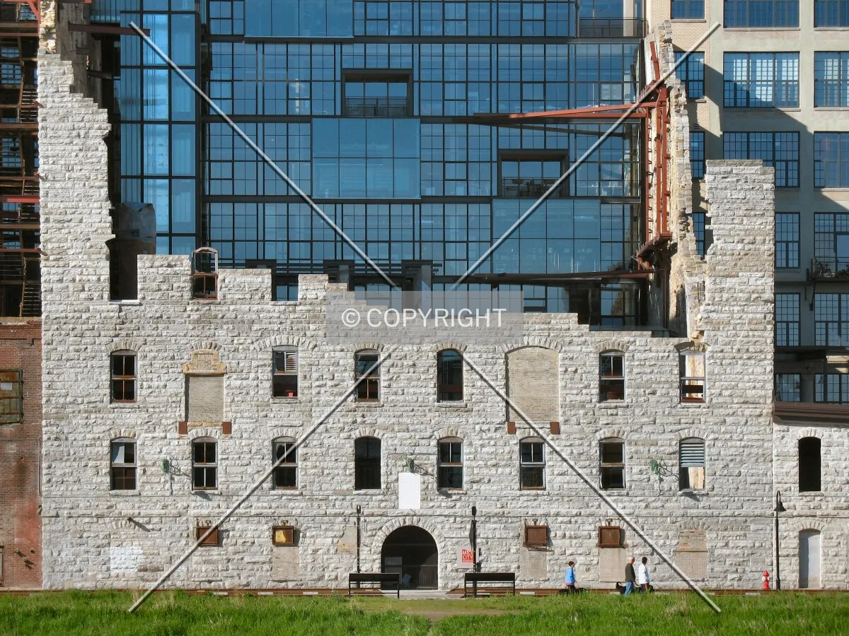 Ruins of the original mill enclosing the rear courtyard, from the Stone Arch Bridge