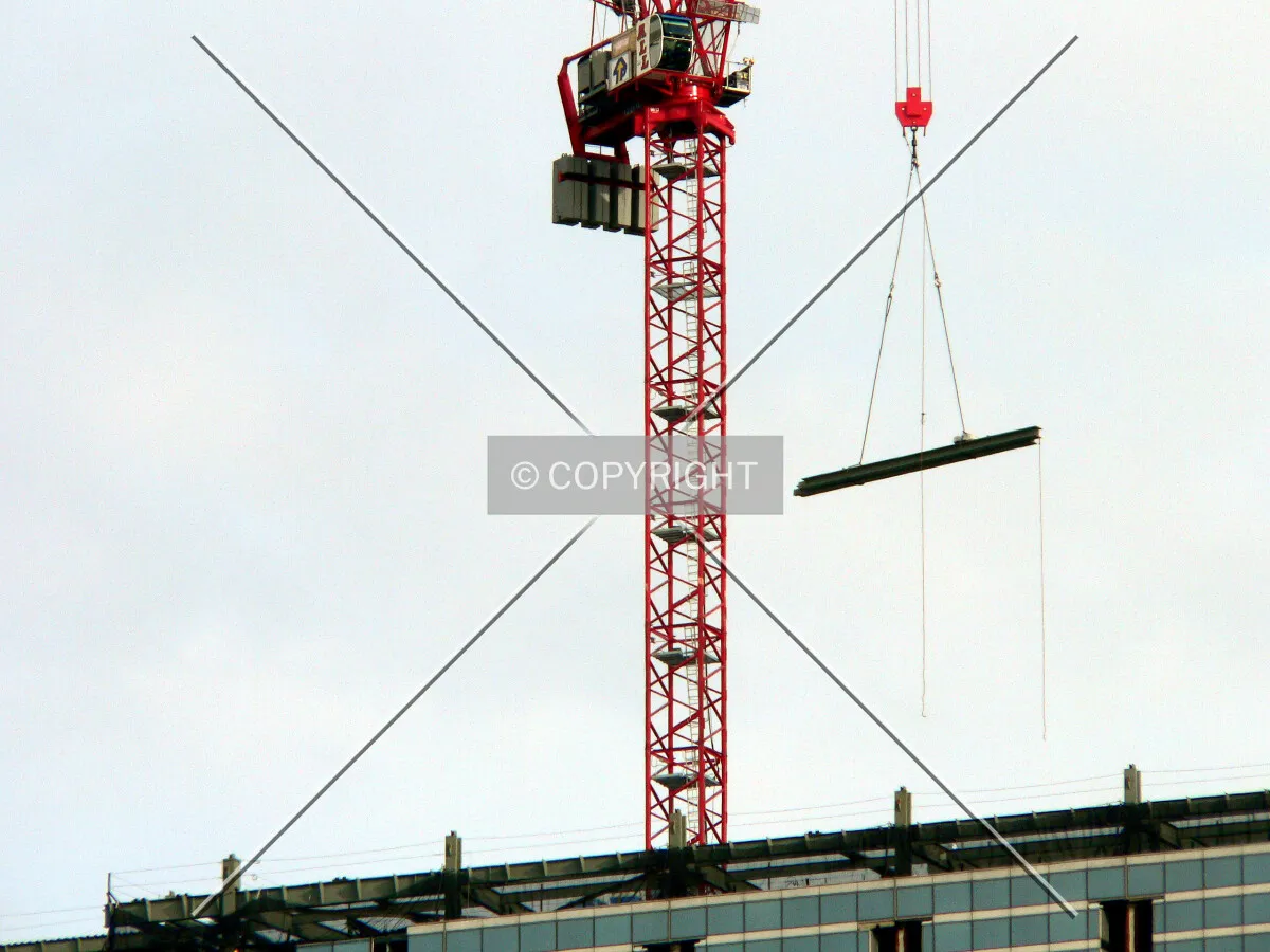 Tower crane setting a piece of steel