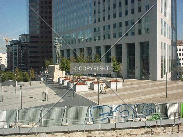 In front of the building; as seen from nearby La Défense passenger bridge
