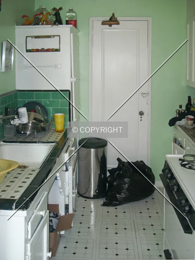 A kitchen with light green walls