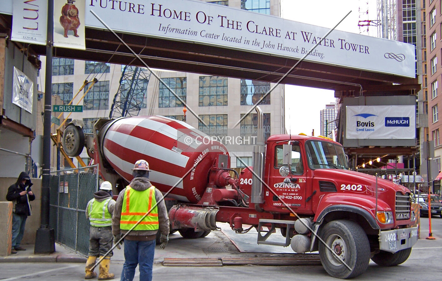 An Ozinga Concrete truck backs into the work site