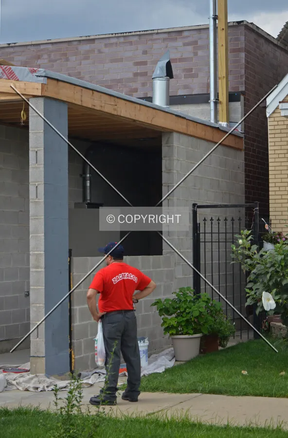 Concrete masonry unit wall at the east end of the building along 59th Place. September 11, 2013.