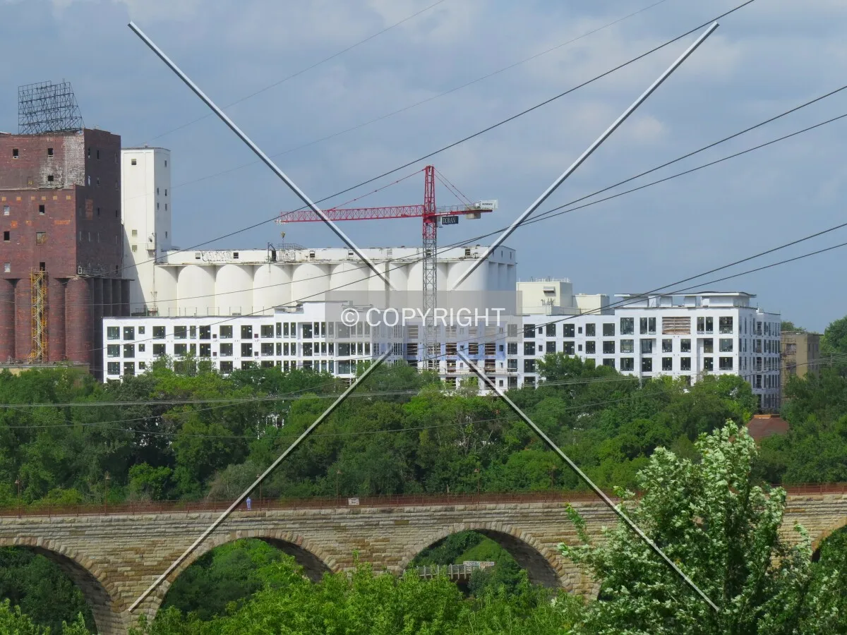 Distant view across the Mississippi River and Stone Arch Bridge from Gold Medal Park