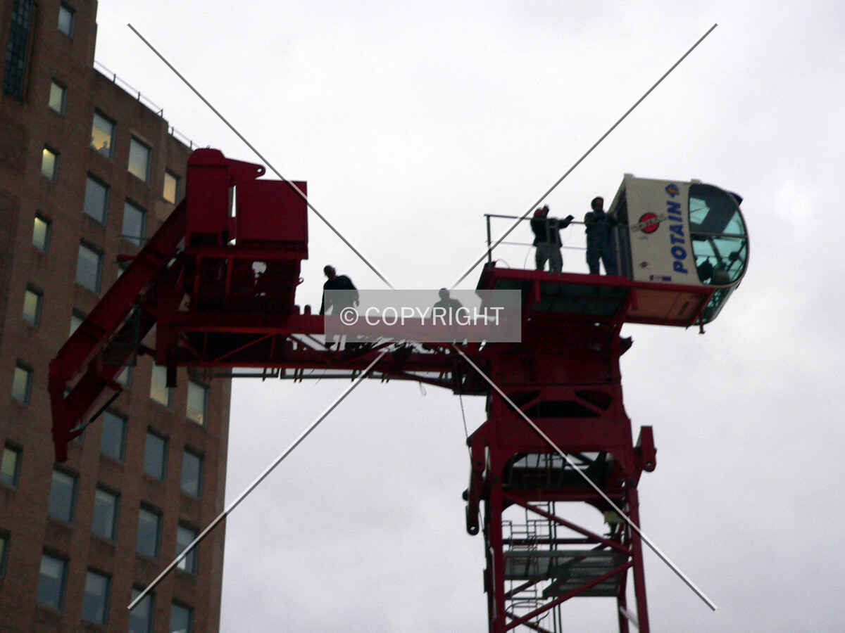 Workers installing the tower crane
