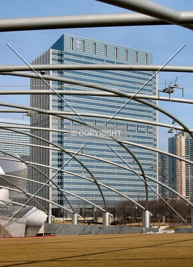 Rising beyond the steel of the Pritzker Pavilion in Millennium Park