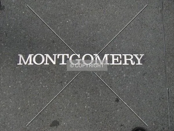 Brass embedded street name on sidewalk