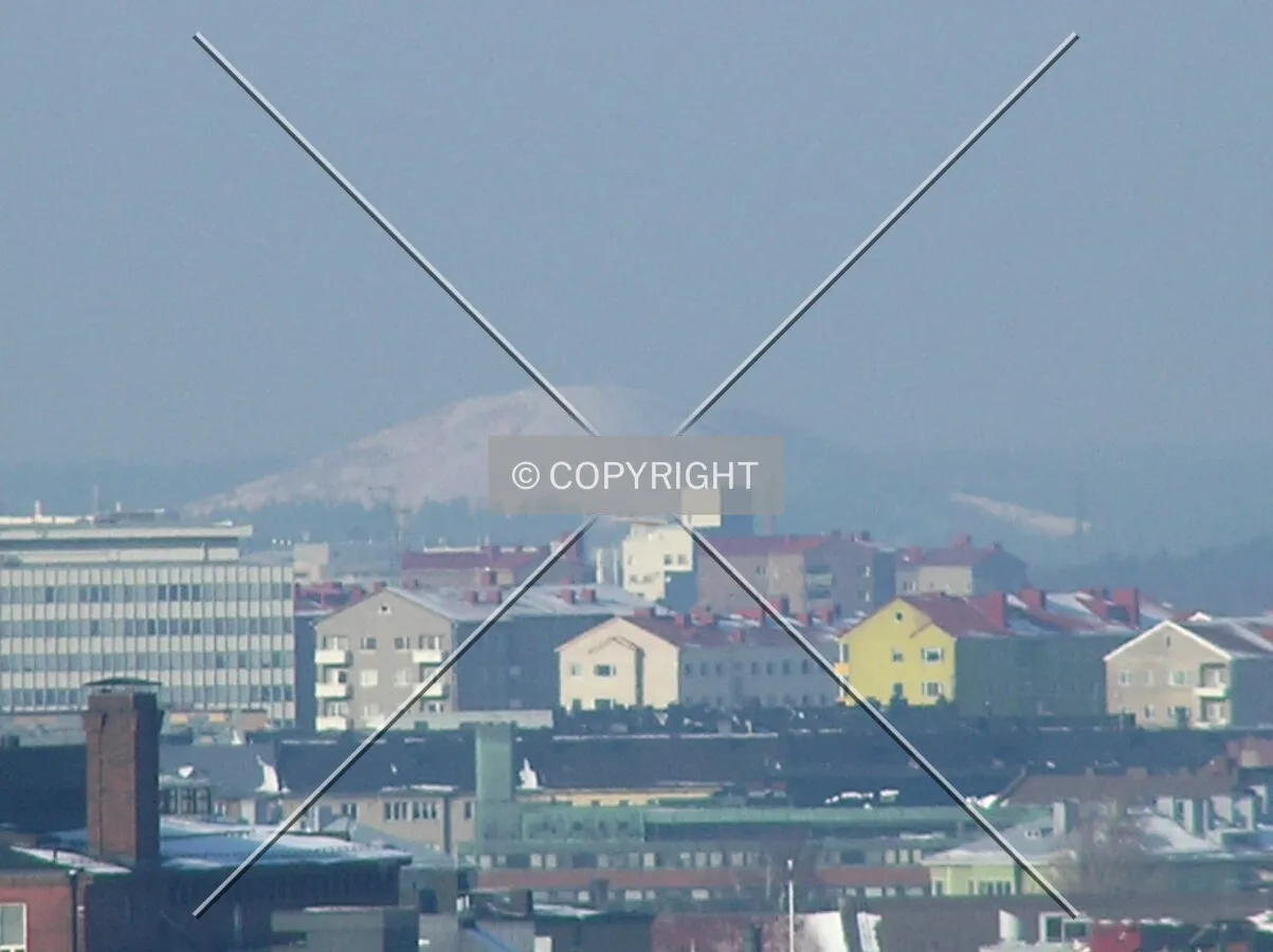 Rooftops and highest hill with snow cover