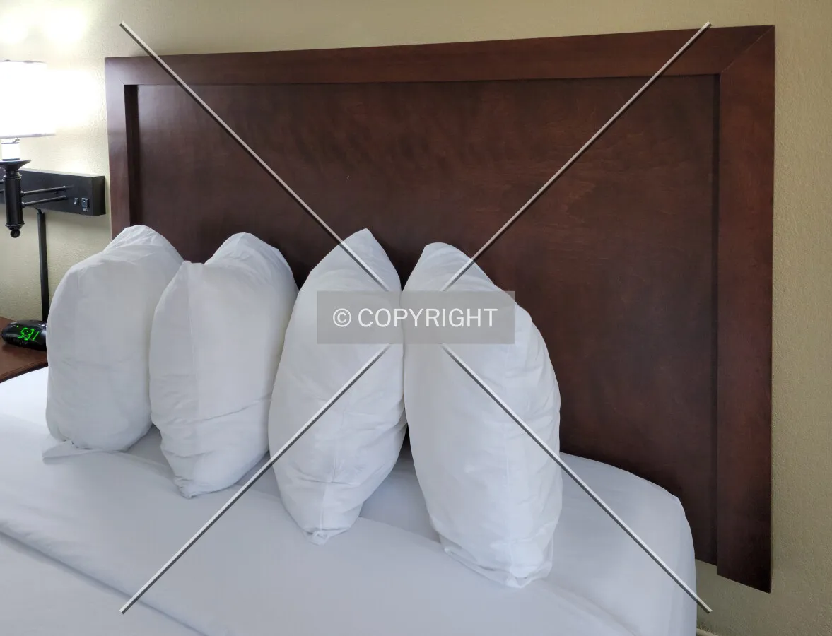 Pillows and headboard of a guest room bed; March 19, 2021