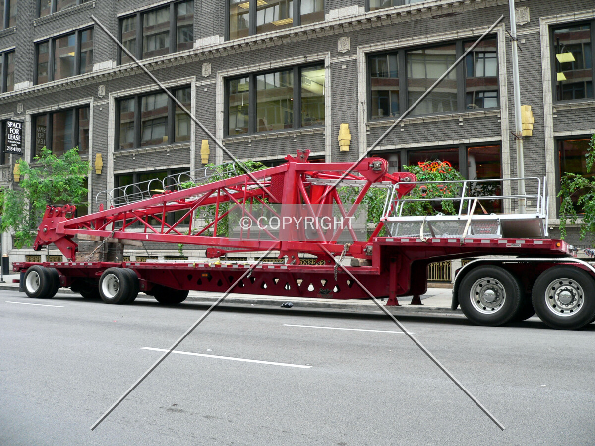 The jib portion of the tower crane laying on a flatbed truck