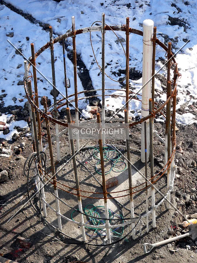 Steel rebar sticking out of the ground where a caisson is located
