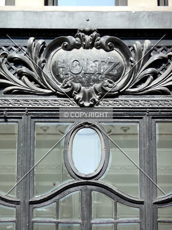 Window detail at the top of the storefront