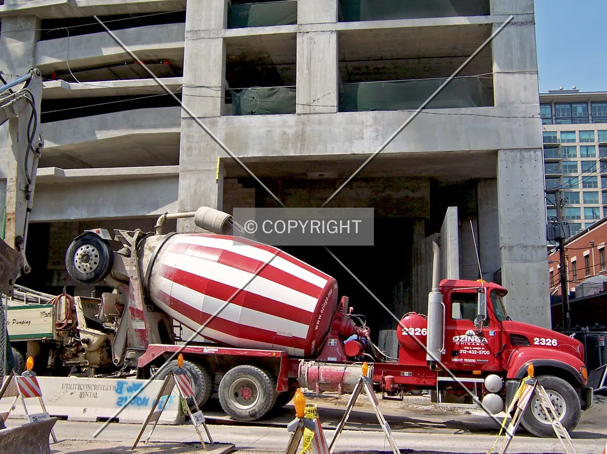 A concrete truck making a delivery on East 14th Street which is dumped straight into a concrete pump