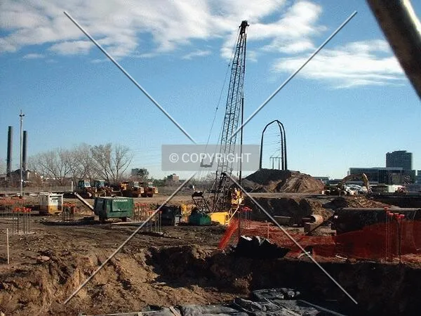 Survey of pit, with caisson drilling rig in background