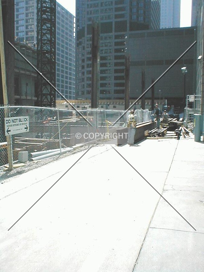 Workers waiting for crane to hoist steel beams into place