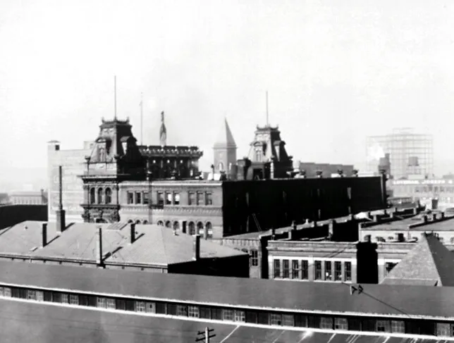 View from the southeast of the building's upper stories with the City Hall tower behind