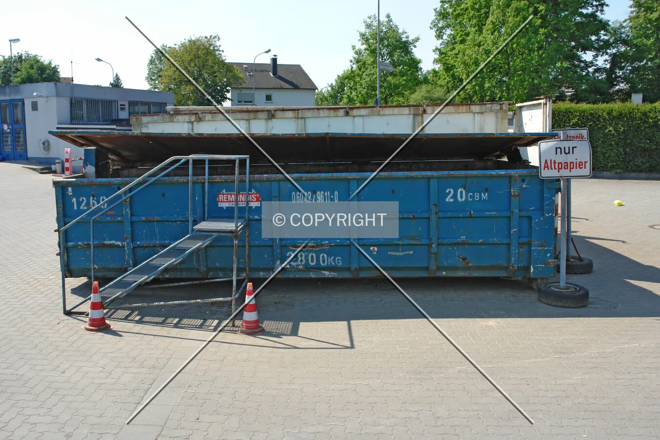 A blue container used for waste paper collection