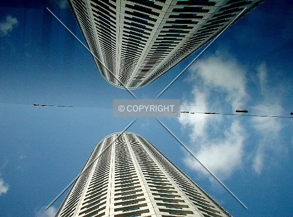 Building reflecting on a nearby glass structure