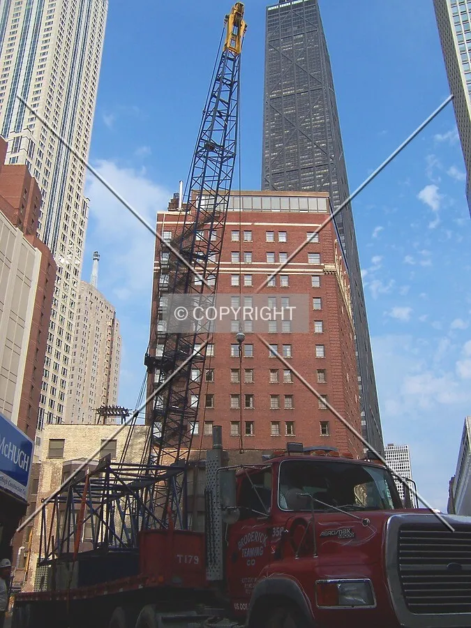 A truck delivers a crane section to the site the day before caisson drilling begins