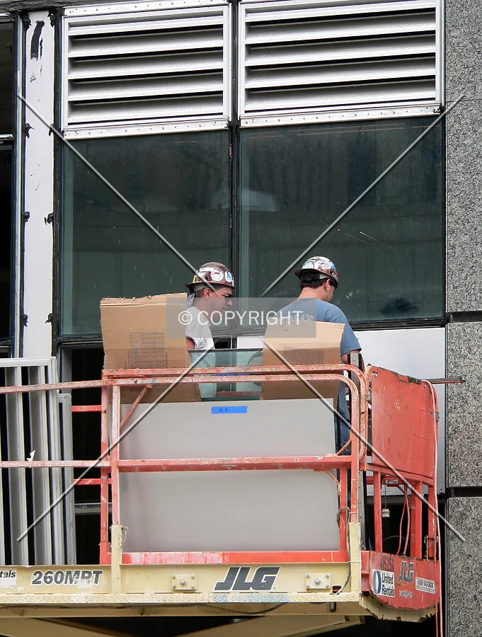Installing windows in the lower levels of the structure around the lobby entrance