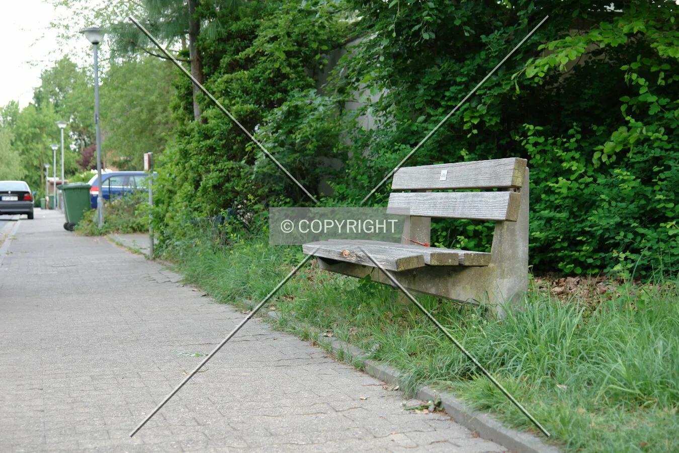 A park bench next to a street