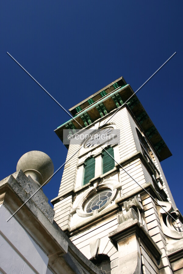 The south side and finial atop a buttressed arch
