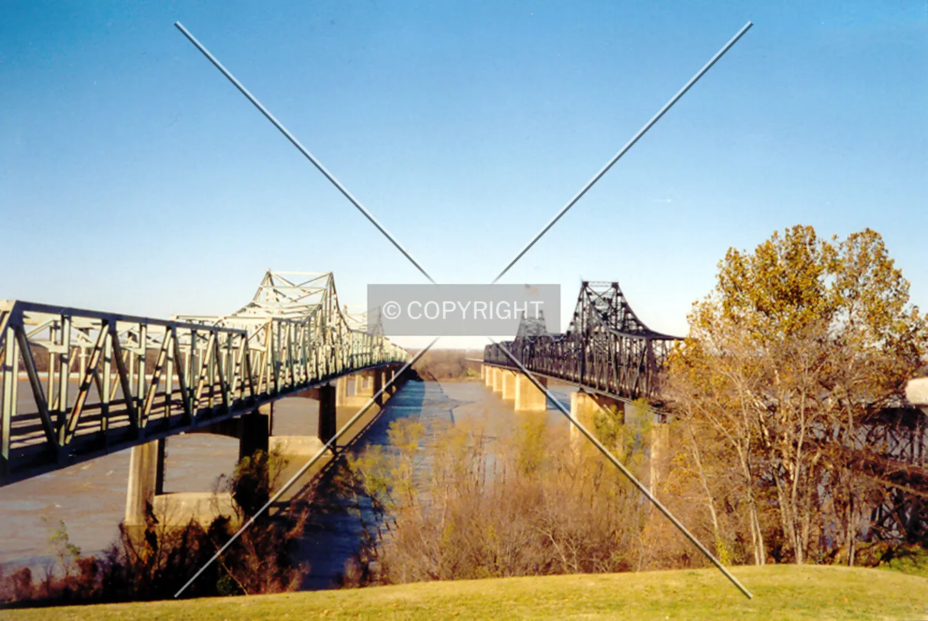 Looking west across the Mississippi River from the Mississippi Welcome Center with Interstate 20 on the left and the old railroad truss on the right