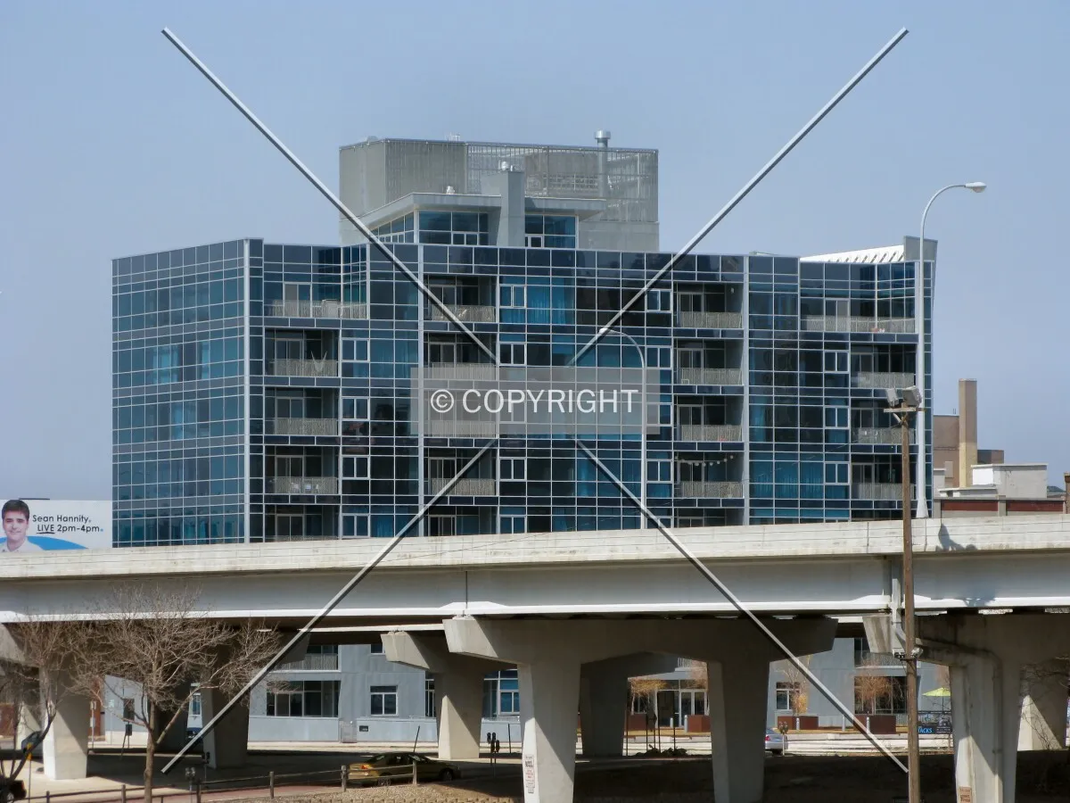 Distant view to the north from 5th Street North, top floors rising beyond the 4th Street onramp to Interstate 94 West