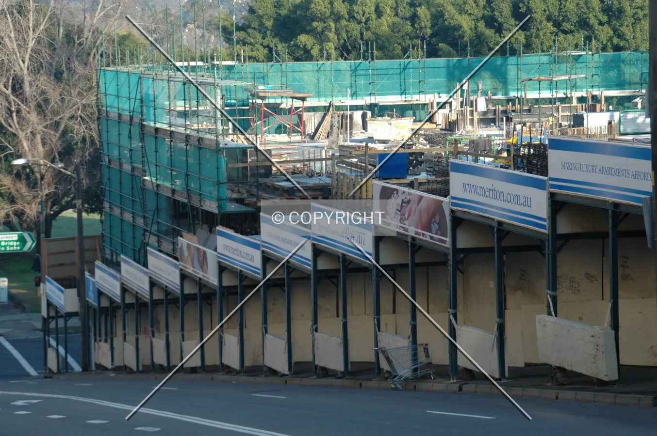 Hoardings along the steep grade of William Henry Street