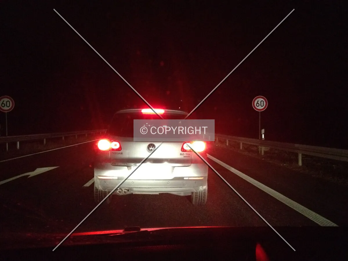 A car is applying the brakes at night