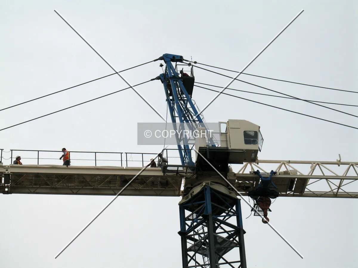 Men at work atop the crane while still in the assembly process