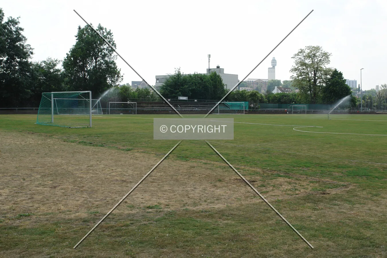 A soccer field been watered
