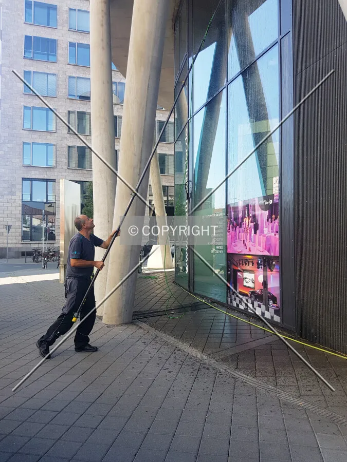 A man is cleaning the facade