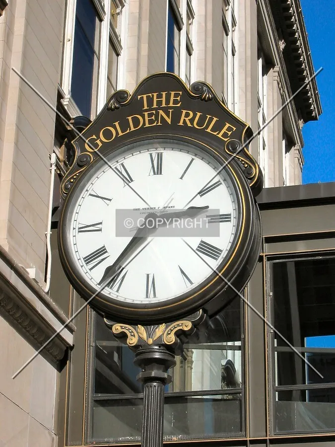 Sidewalk clock along East 7th Place
