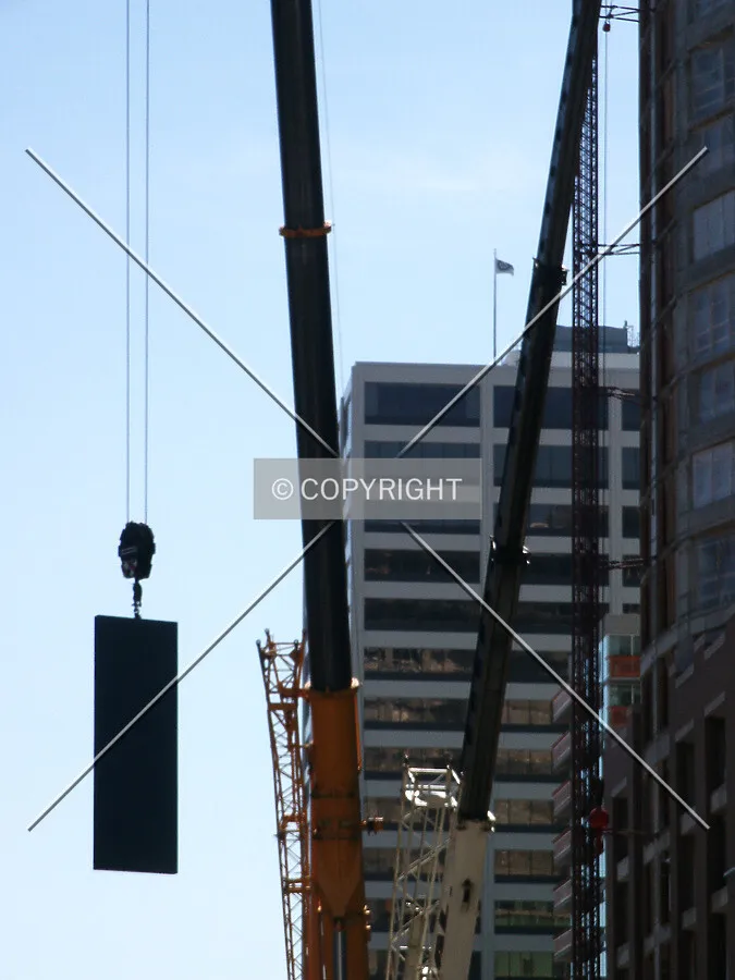 Looking south on Sherman Avenue with the crane weight being lowered