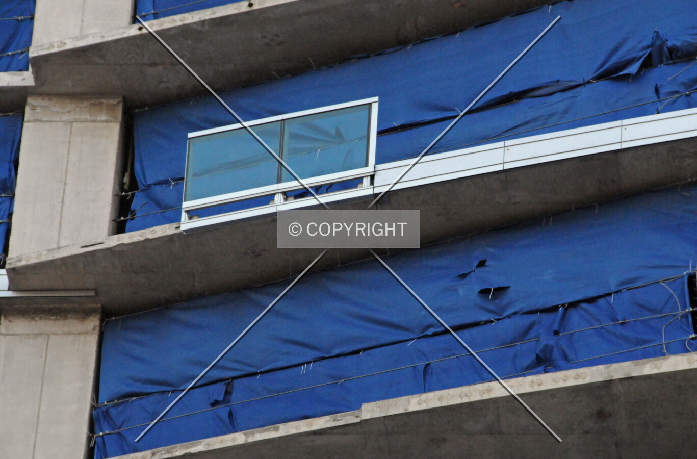 Single section of a glass balcony railing and slab edge covers on the north facade
