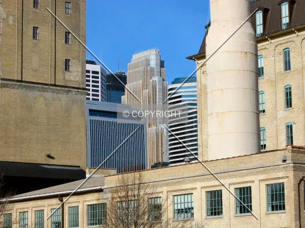 Recognizable towers framed by the Ceresota Building and the Crown Roller Mill, from the Stone Arch Bridge