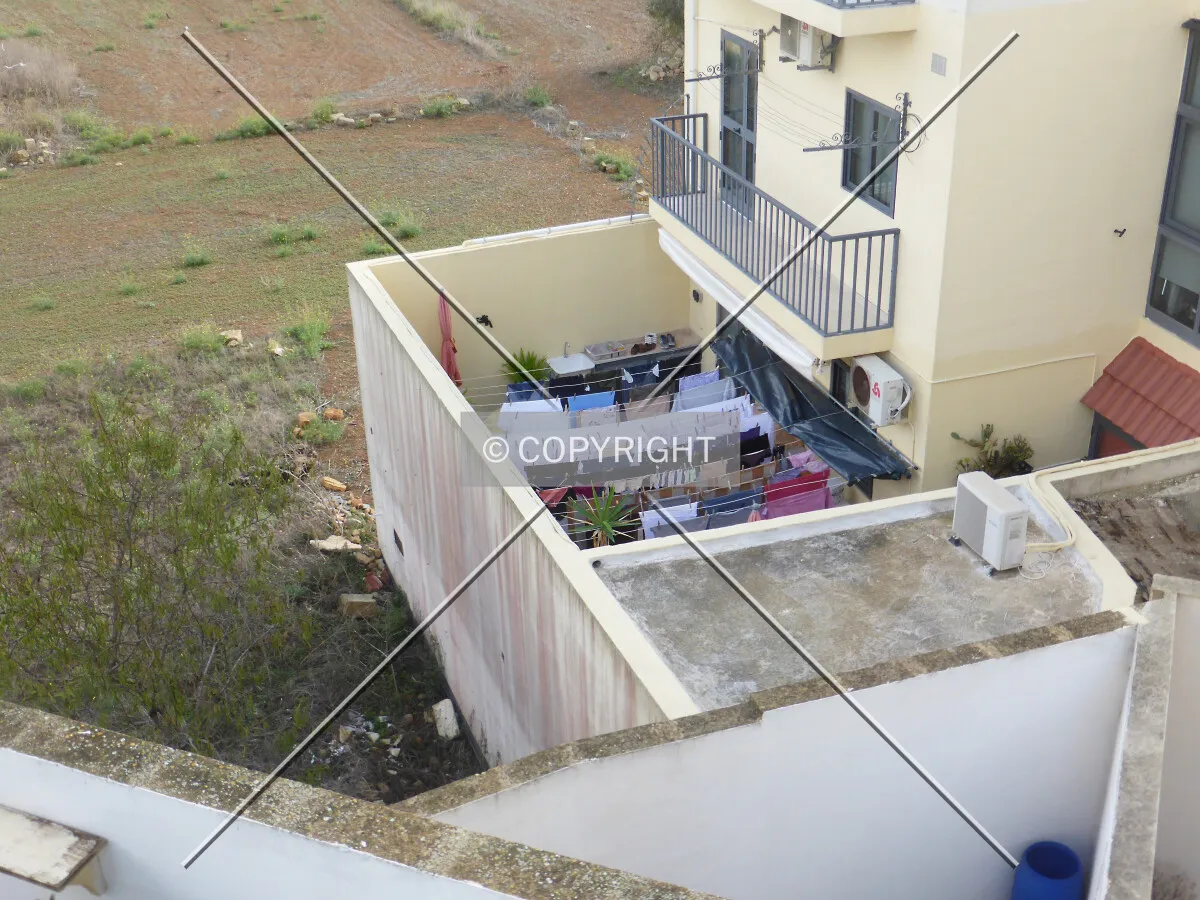 Typical maltesian architecture in Il-Gudja, Malta - where average people live. Here you see a fenced courtyard surrounded by tall walls.