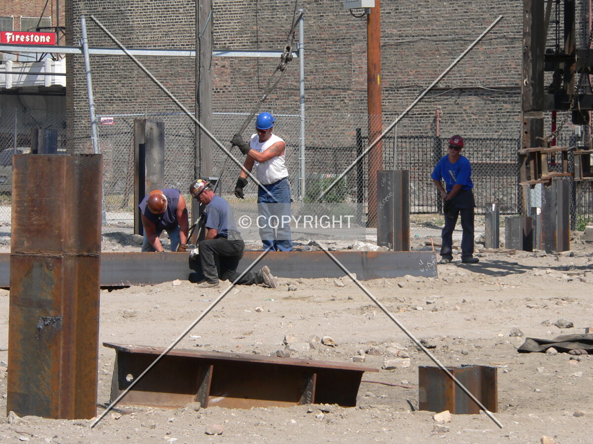 Workers connecting a line to a steel pile