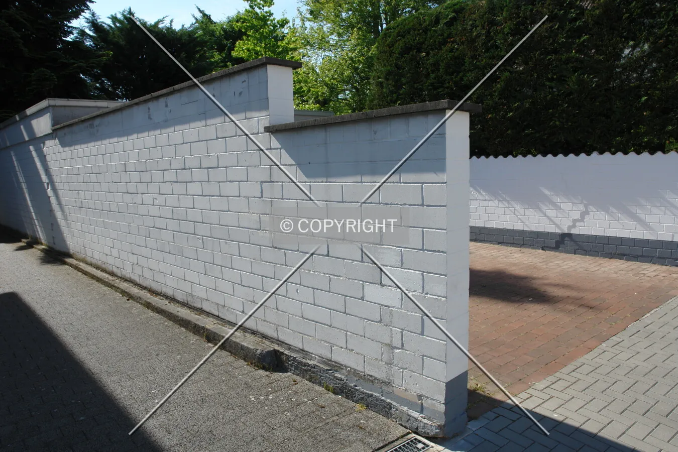 A white stone wall to prevent viewing and accessing a site