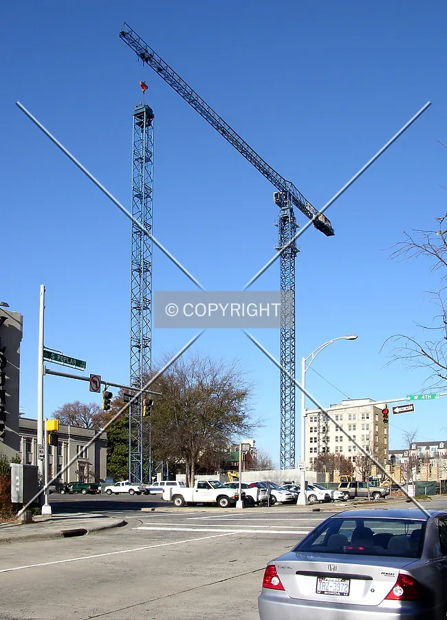 Assembly of the second tower crane continues, view from the southeast along South Poplar Street