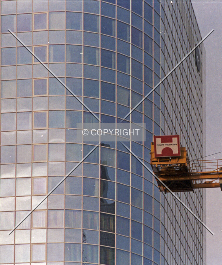 Philipp Holzmann logo in front of a glass facade of a neighboring building