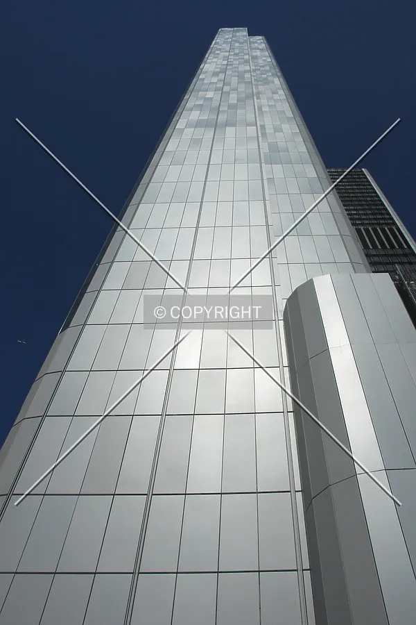 Looking up the facade of the skyscraper; tiles forming a nice visual effect