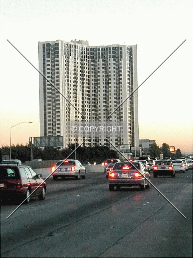 Freeway traffic and Emeryville's tallest near sunset