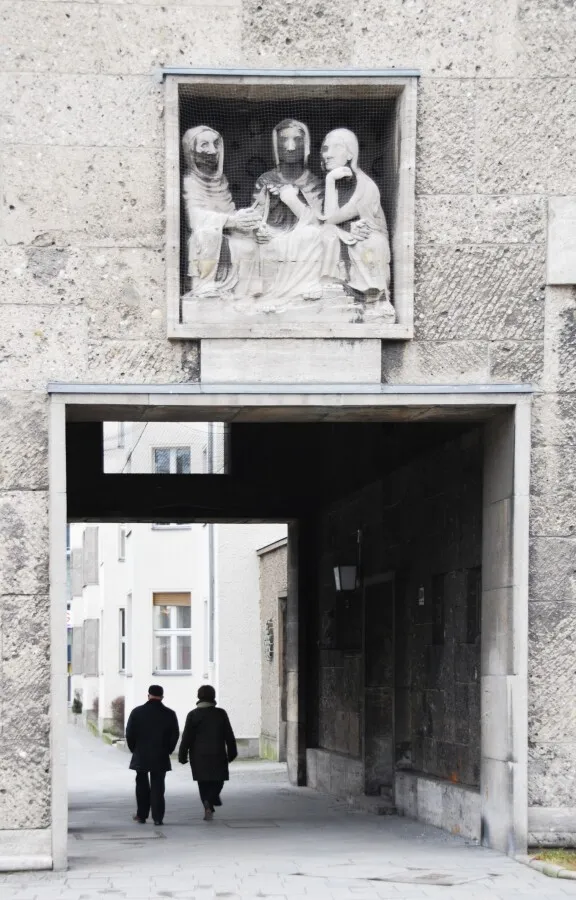 Pedestrian tunnel through the building with stone motifs over the tunnel entrance